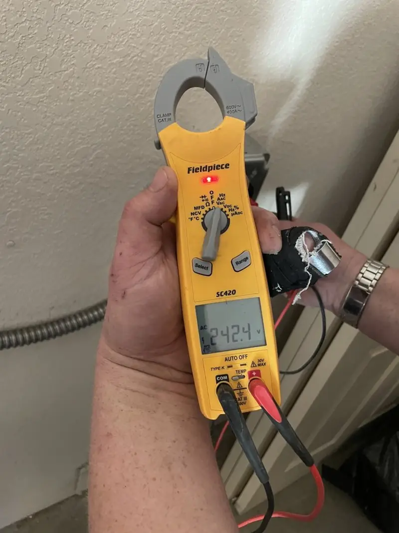 Voltage testing with clamp meter during Electrical Installation Services in Ringgold